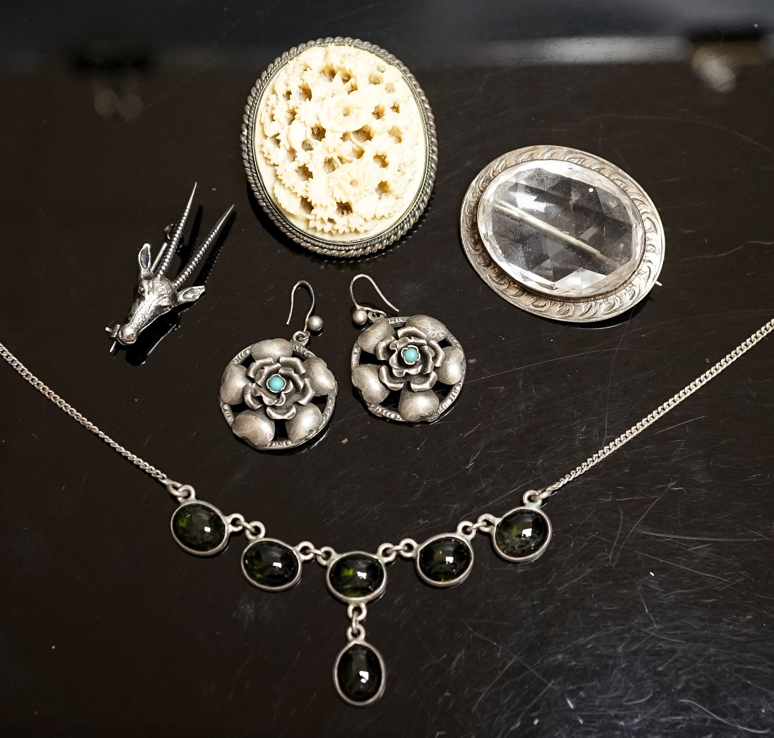 A pair of white metal and turquoise set earrings, a gem set necklace, deer head brooch and two oval brooches.